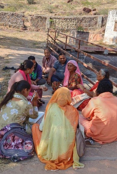 A group of people sitting on the ground  AI-generated content may be incorrect.